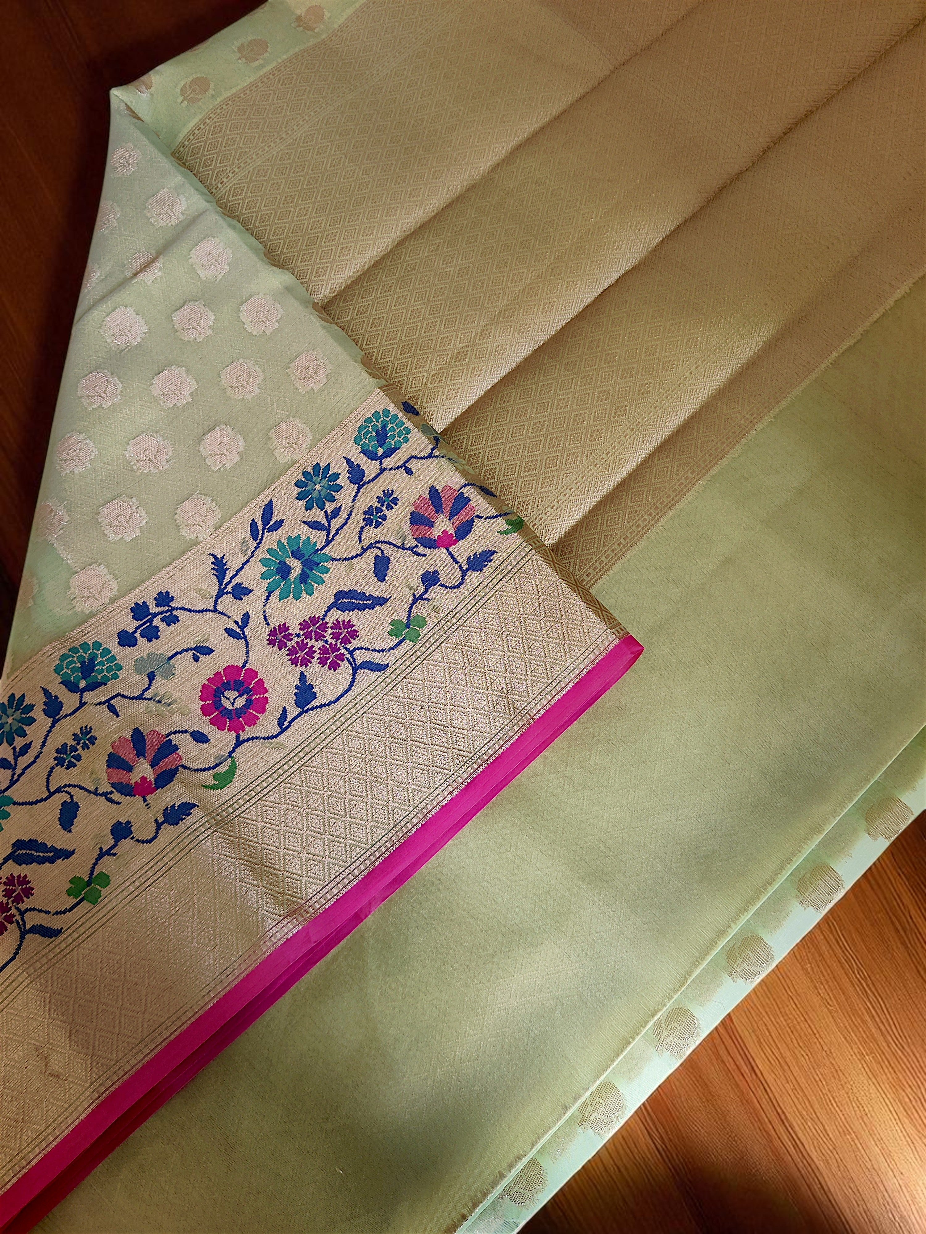 Green Banarasi Saree featuring intricate Meenakari border.