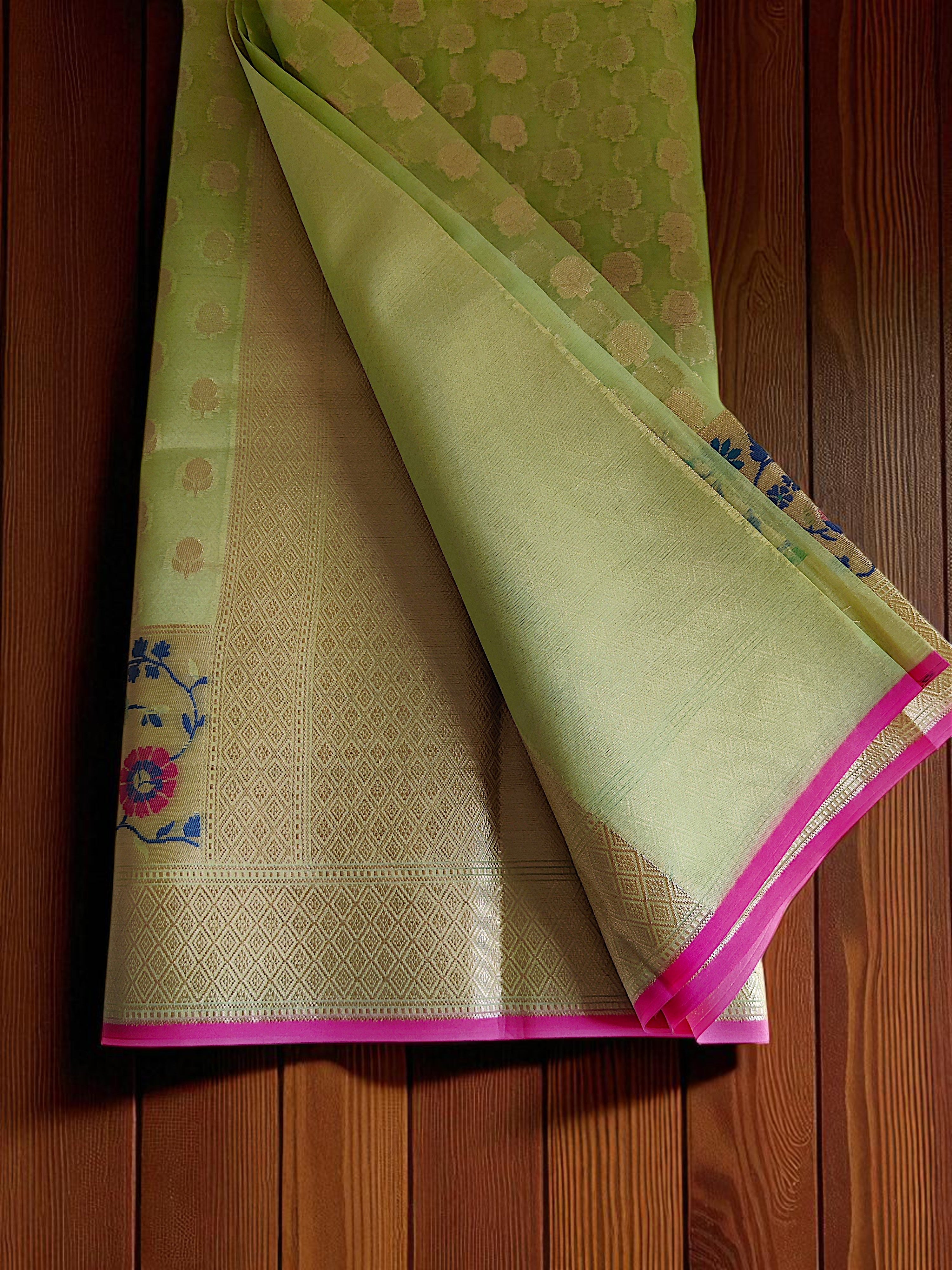 Green Banarasi Saree featuring intricate Meenakari border.