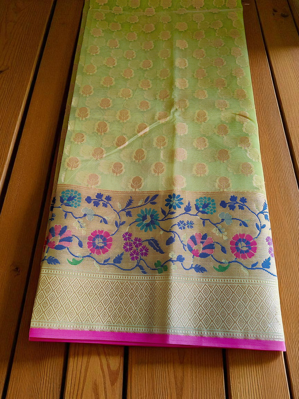 Green Banarasi Saree featuring intricate Meenakari border.